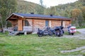 Various motorcycles in front of a log cabin in Utsjoki, Finnish Lapland. Royalty Free Stock Photo