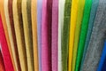 Various multi-colored fabrics. Fabrics in a store on the counter. Colorful abstract background