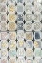 Various nail art beads, gemstones and accessories neatly organized in clear containers