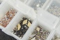 Various nail art beads, rhinestones and accessories neatly organized in clear containers