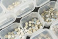 Various nail art rhinestones and accessories neatly organized in clear containers