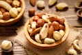 Various nuts in bowl - cashew, hazelnuts, almonds, brazilian nuts and macadamia on a wooden table.