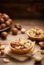 Various nuts in bowl - cashew, hazelnuts, almonds, brazilian nuts and macadamia on a wooden table.