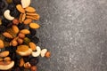 Various nuts isolated on dark background. pecan, macadamia, brazil nut, walnut, almonds, hazelnuts, cashews. Copy space.