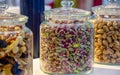 Various nuts and seeds in glass jars over white wooden table against white background. The concept of vegetarian and organic food Royalty Free Stock Photo