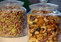 Various nuts and seeds in glass jars over white wooden table against white background. The concept of vegetarian and organic food Royalty Free Stock Photo