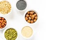 Various Nuts and Seeds on White Background in the Bowls with Free Space for Text Royalty Free Stock Photo