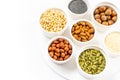 Various Nuts and Seeds on White Background in the Bowls with Free Space for Text