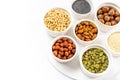 Various Nuts and Seeds on White Background in the Bowls with Free Space for Text Royalty Free Stock Photo