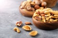 Various nuts in a wooden bowl on gray table. Close-up. Space for text Royalty Free Stock Photo