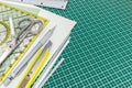 Various office or school supplies on green cutting mat Royalty Free Stock Photo