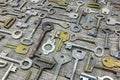 Various old rusty keys on gray wooden desk Royalty Free Stock Photo