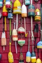 Various onboard used floats for mooring boats and schooners are decoratively hung on the wall of the building