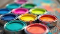 Various open paint cans with vibrant colors on wooden surface. Art supplies ready for creative projects. Colorful liquids show Royalty Free Stock Photo