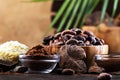 Various organic cocoa products. Cocoa beans, cocoa powder, cocoa butter, dark chocolate, liquid chocolate, grated cocoa on wooden Royalty Free Stock Photo