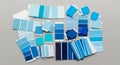 Various paint sample cards and chips scattered on a gray surface. The samples Royalty Free Stock Photo