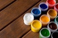 Various paints on the old wooden table . Creative concept
