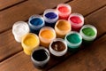 Various paints on the old wooden table . Creative concept