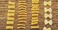 Various pasta on wooden table