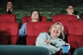 Various people enjoy watching funny cinema in movie theaters.