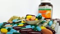 Various pharmaceutical medicine pills, orange tablets, blue and green capsules Royalty Free Stock Photo