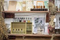 Various pharmacy bottles with homeopathic medicines on wooden shelves of an old pharmacy