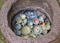 Various pieces of unfired pottery filled in earthen firing chamber of a primitive pit kiln