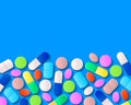 Various pills, tablets and capsules on blue background Royalty Free Stock Photo