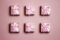 A various pink gift boxes pink red ribbon over the pink background. Royalty Free Stock Photo