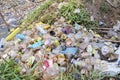 Various plastic waste heaps on the riverside