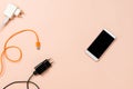 Various plugs and cables with a smartphone with black copyspace on pastel background Royalty Free Stock Photo
