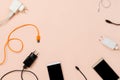 Various plugs and cables and smartphones on pastel background Royalty Free Stock Photo