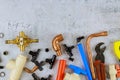 Plumbing tools, pipe fittings on a home improvement plumbing materials including copper pipe, elbow joint, wrench and spanner Royalty Free Stock Photo