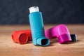 Asthma inhalers on a wooden table