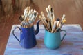 Various professional paint brushes in the blue metal jar Royalty Free Stock Photo