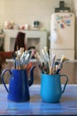 Various professional paint brushes in the blue metal jar Royalty Free Stock Photo