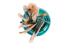 Various professional paint brushes in the green glass jar Royalty Free Stock Photo
