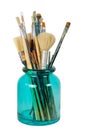 Various professional paint brushes in the green glass jar Royalty Free Stock Photo