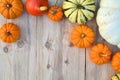 Various pumpkins and squashes on wooden background Royalty Free Stock Photo