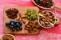 Various raisins, vine berries and almonds on chopping board Royalty Free Stock Photo