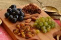 Various raisins, vine berries and almonds on chopping board Royalty Free Stock Photo