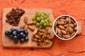 Various raisins, vine berries and almonds on chopping board Royalty Free Stock Photo