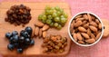 Various raisins, vine berries and almonds on chopping board Royalty Free Stock Photo