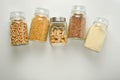 Various raw cereals in glass jar. Zero waste concept. Food storage. Flat lay. White background Royalty Free Stock Photo