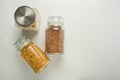 Various raw cereals in glass jar. Zero waste concept. Food storage. Flat lay. White background Royalty Free Stock Photo