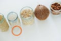 Various raw cereals, grains in glass jars.