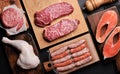 Various raw meat and fish. Steaks, sausages, salmon, chicken and spices