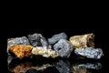 Various raw ore gemstones or rocks on black background, mining and geology