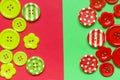 Various red and green sewing buttons on red and green background Royalty Free Stock Photo