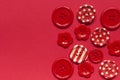 Various red sewing buttons on red background Royalty Free Stock Photo